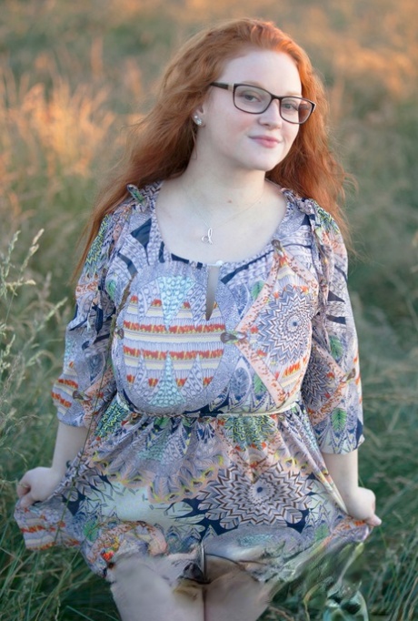 Hot redhead BBW Kaycee looses her huge tits and gets on her knees in a field 97361629