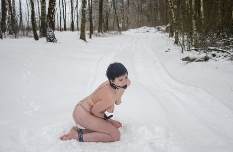 Naked girl with short hair sports a ball gag while cuffed at wrists and ankles 74518256