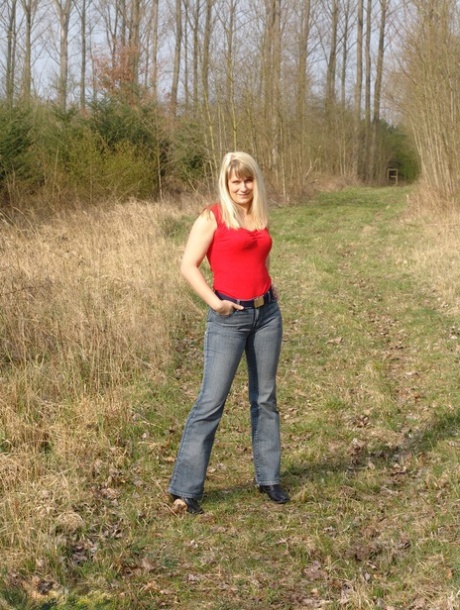 Curvy blonde Sweet Susi pulls out a smoke after getting naked in woods 48885624
