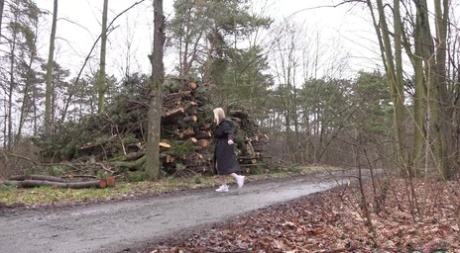 Blonde girl Nikki Dream squats for a piss near fresh-cut softwood trees 60128858