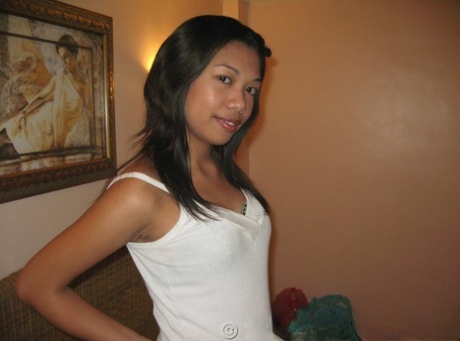Pinay amateur Bianca gets undressed for a nude solo shoot on a bed 29291656