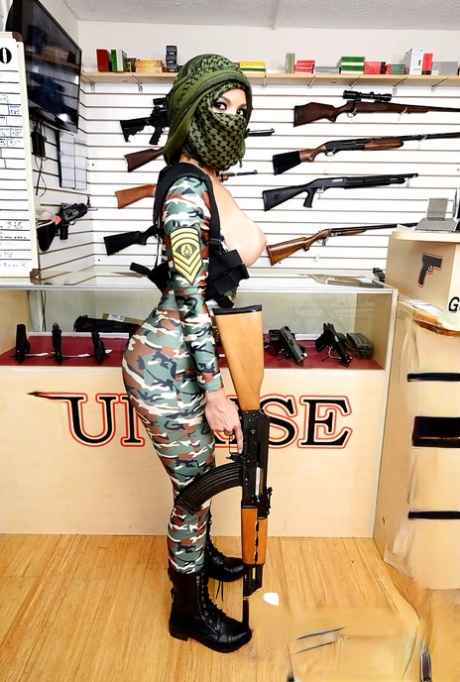 Camouflaged chick with rifle in hand lets her big natural breasts loose 14277986